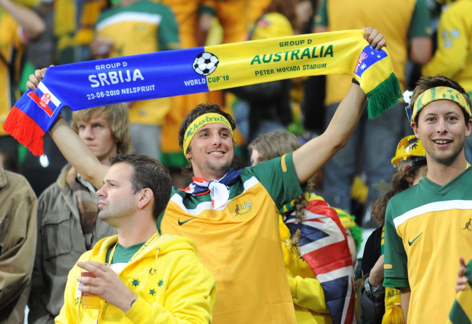Australia fan holding up a World Cup matchday scarf in the stadium