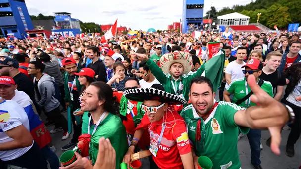 Mexico supporters in green jerseys and sombreros celebrating together