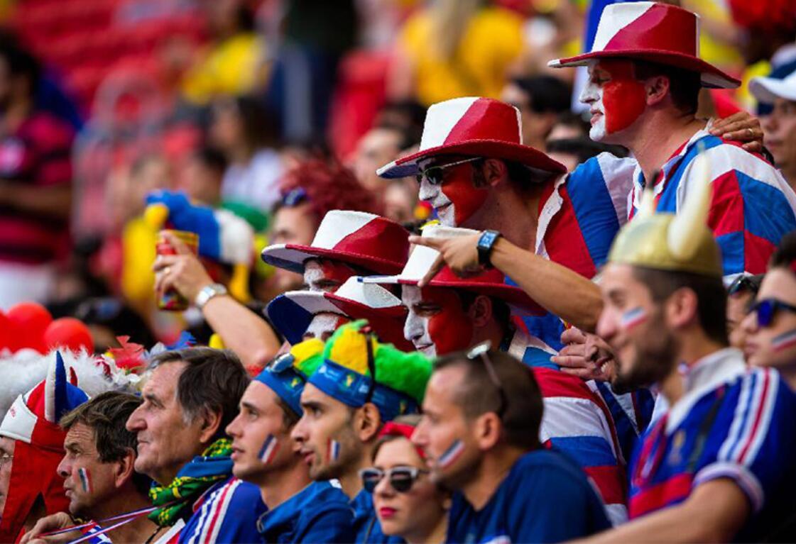 France supporters in coordinated red, white and blue hats and face paint